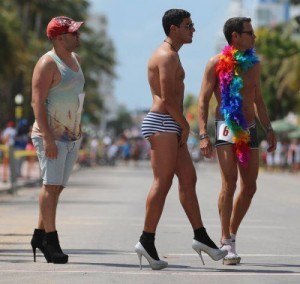 MIAMI BEACH, FL - APRIL 14: Juan Cuba Lorded, Teddy Fournier and Bob Micket (L-R) stand at the start line for the Azucar High Heel Race before the beginning of the Fifth annual Miami Beach Gay Pride Parade along Ocean Drive on April 14, 2013 in Miami Beach, Florida. The race participants according to the rules had to  wear high heels no less than 3 inches, approximatly 10 people entered the race to have a chance of winning the 1st place prize of $500.  (Photo by Joe Raedle/Getty Images)