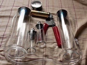 Two penis pump cylinders, a pump, and a pair of nipple pumps too.