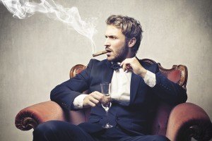 bigstock-boss-smokes-cigar-with-a-glass-43867087-300x200