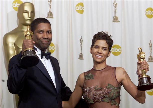 Actor Denzel Washington and actress Halle Berry appear backstage with their Oscar statues at the 74th annual Academy Awards in Hollywood in this March 24, 2002, file photo. REUTERS/Andy Clark/Files