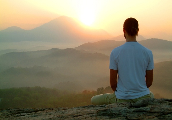 man-meditating-on-mountain