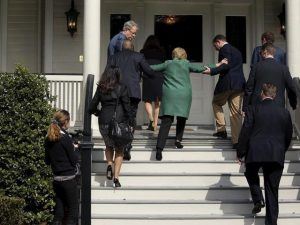 Hillary had to be carried up a flight of stairs as she sports Chairman Mao attire