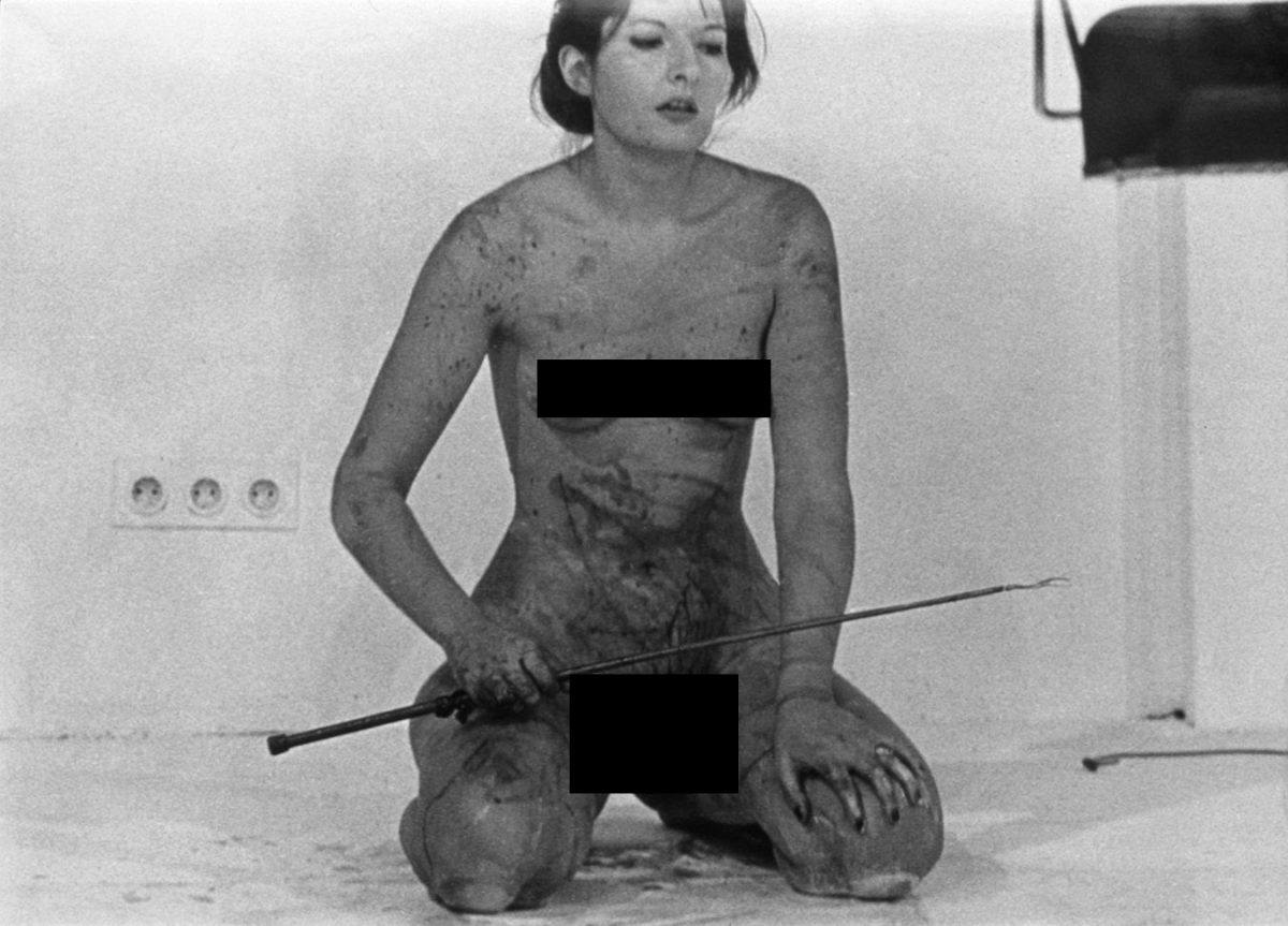Abramovic carving a pentagram in her flesh with a blade to show her artistic side 