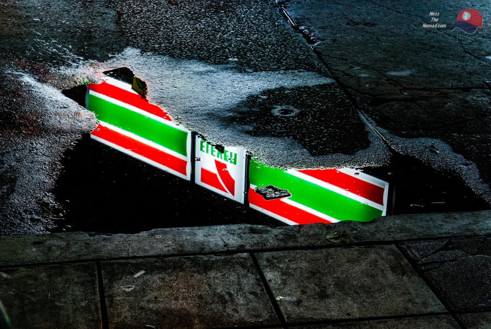7-Eleven Sign Reflected in a Puddle