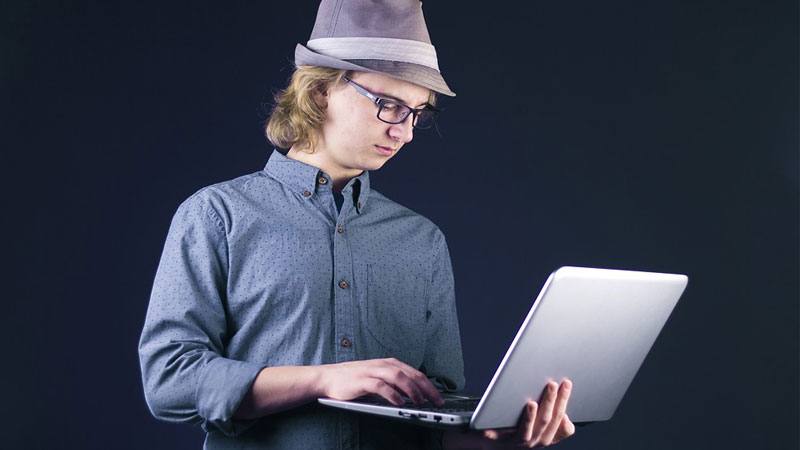 geek guy in front of his laptop
